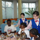 North Korean students serve meals to the other children.
